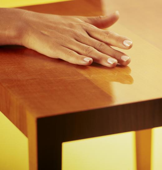 hand-on-glossy-table-surface