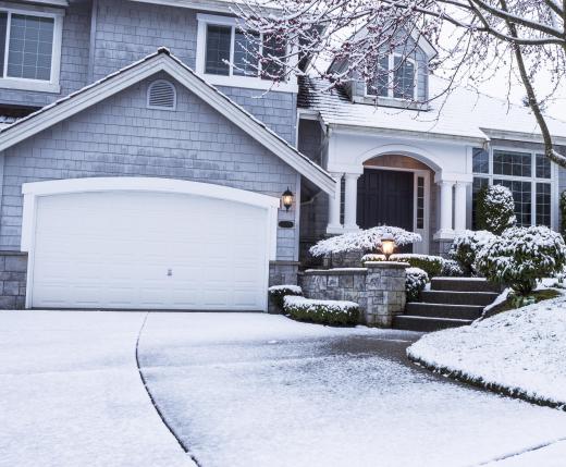 home-with-snow-covered-yard-and-driveway