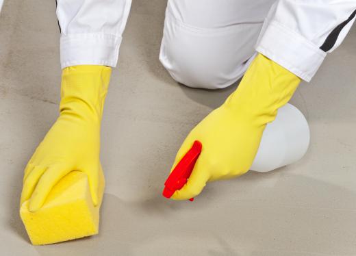 person-on-knees-cleaning-cement-floor