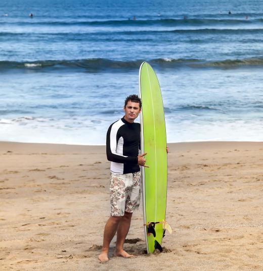 man-with-green-surfboard-near-the-ocean