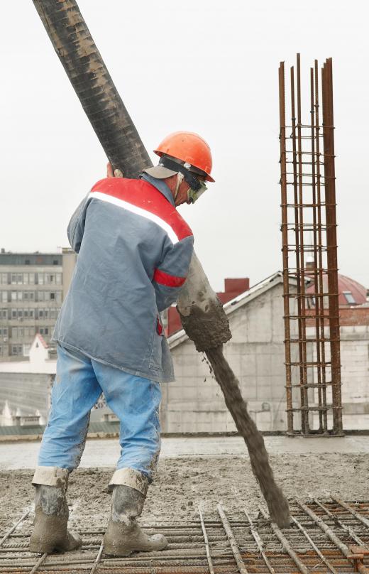 worker-pouring-concrete-from-vibrator